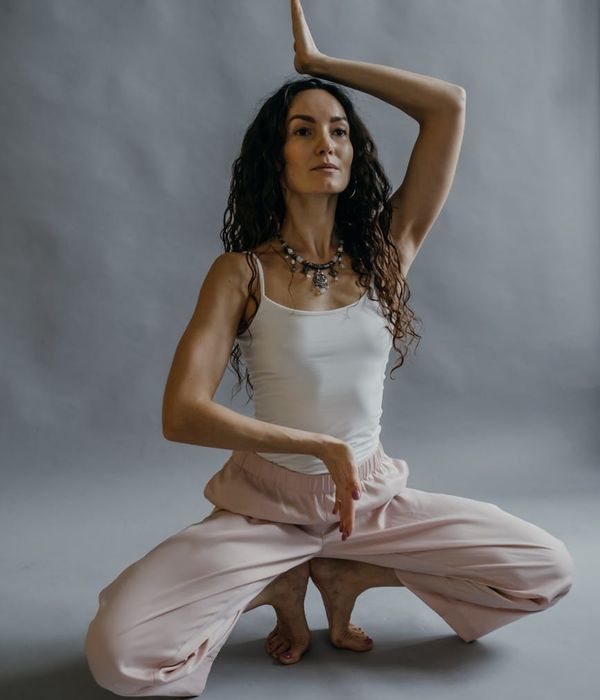 Woman in a calm, graceful pose, embodying inner balance and peace.